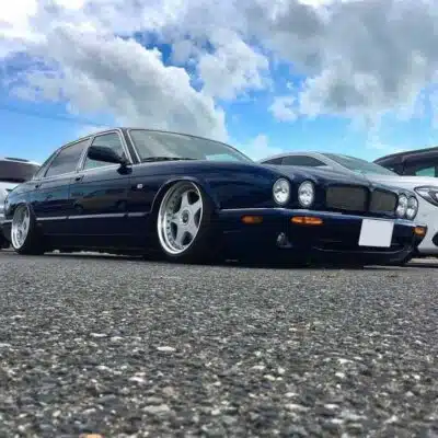 Lowered Jaguar X308 in a parking lot