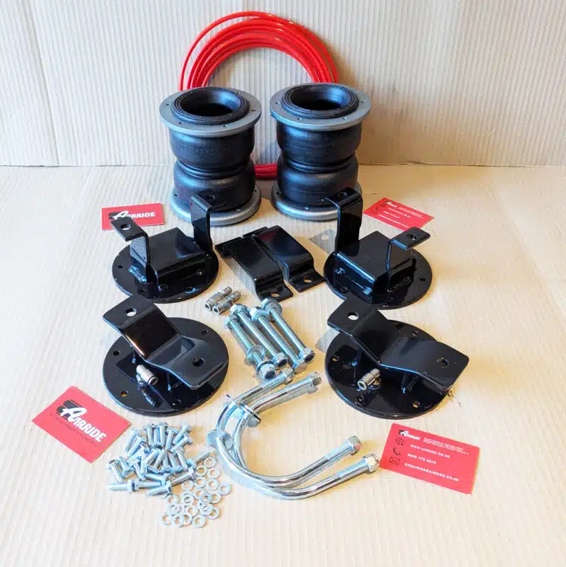 VW Amarok Gen 1 load support kit laid out on beige background
