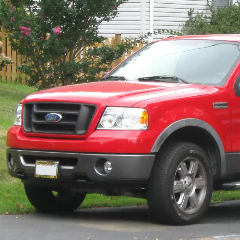 Red Ford F-150 2004-2010 parked outdoors