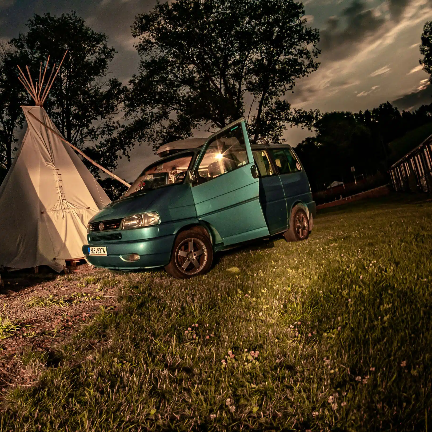 T4 camper parked outside a tent