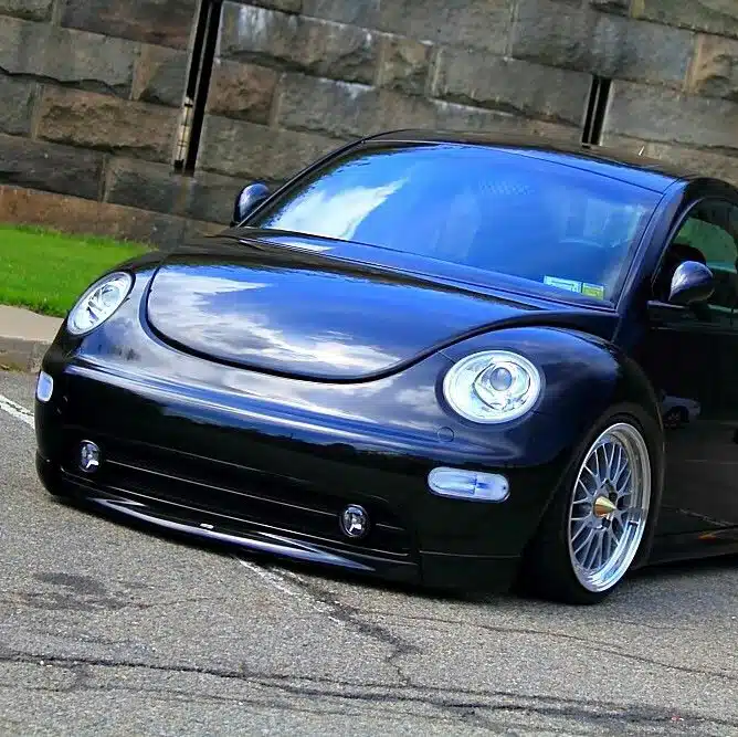 Lowered black VW New Beetle parked outdoors
