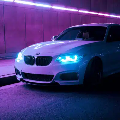 White BMW F22 parked in a neon tunnel