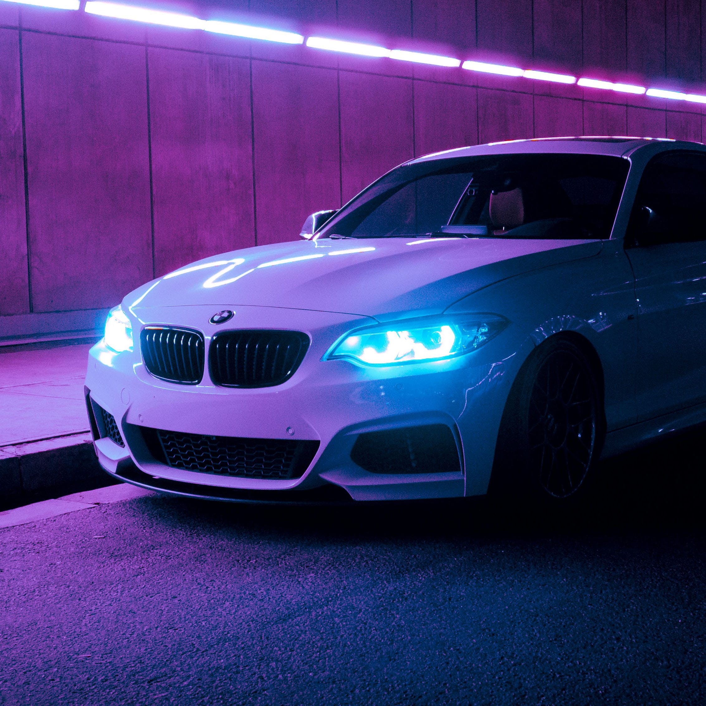 White BMW F22 parked in a neon tunnel