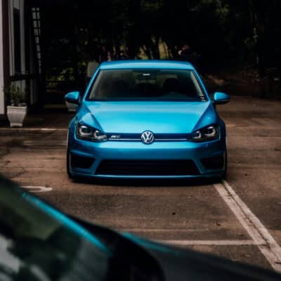 Lowered blue VW Golf R in a parking lot