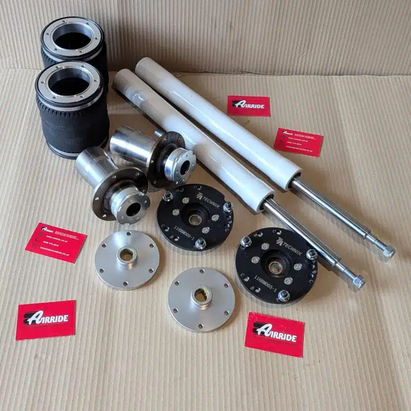 TA Technix BMW E34 front kit laid out on beige background