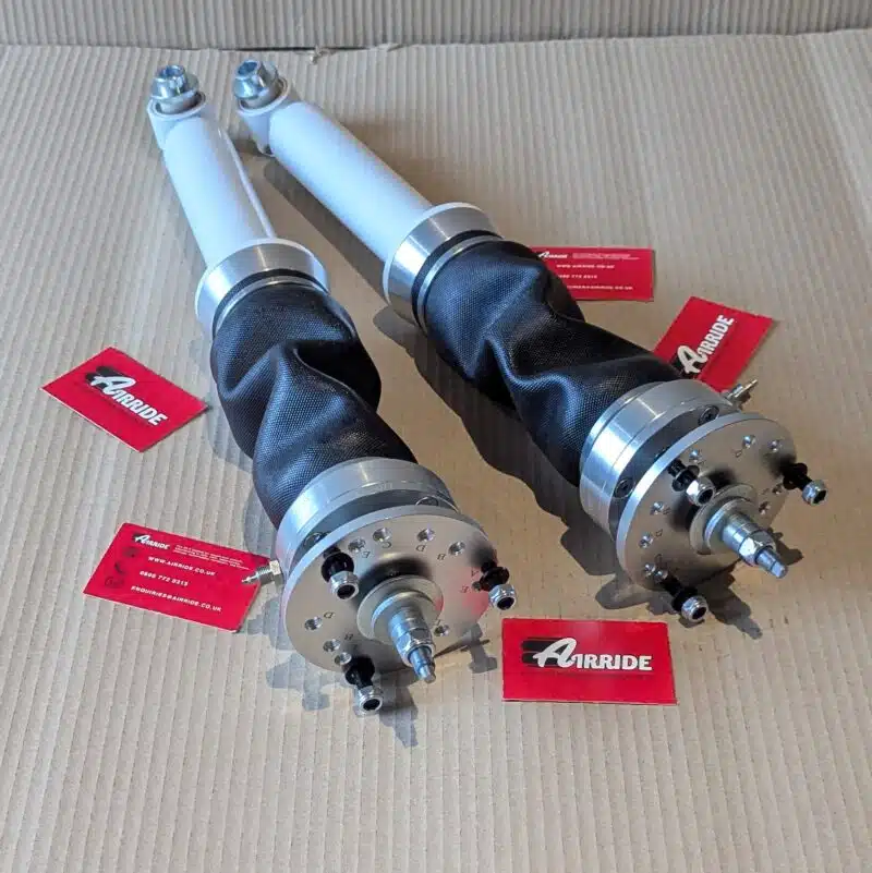 TA Technix BMW E34 rear struts on beige background