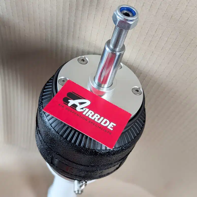 Close up of TA Technix BMW E61 front strut on beige background