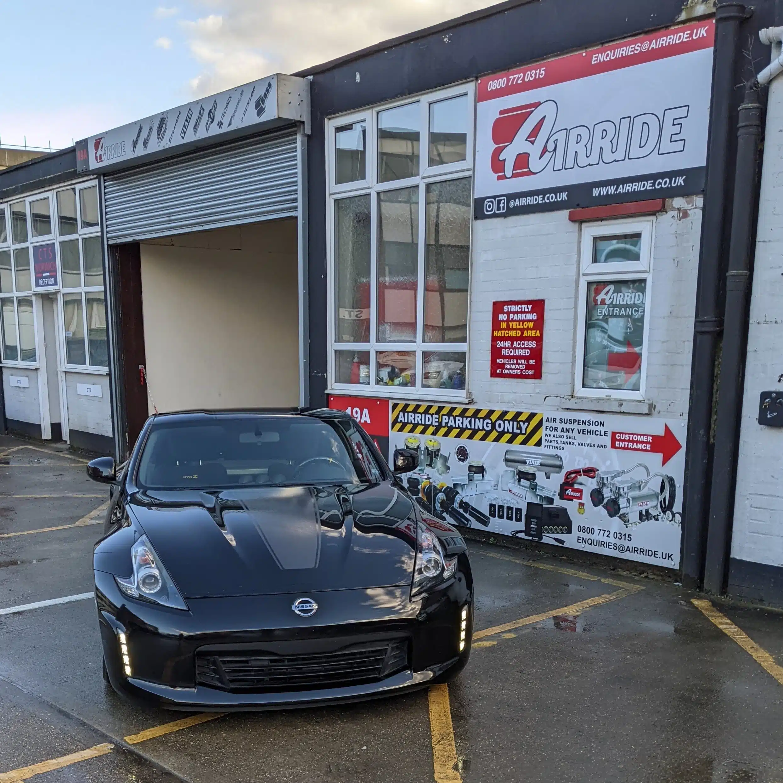 Lowered black Nissan 370Z parked outside AirRide