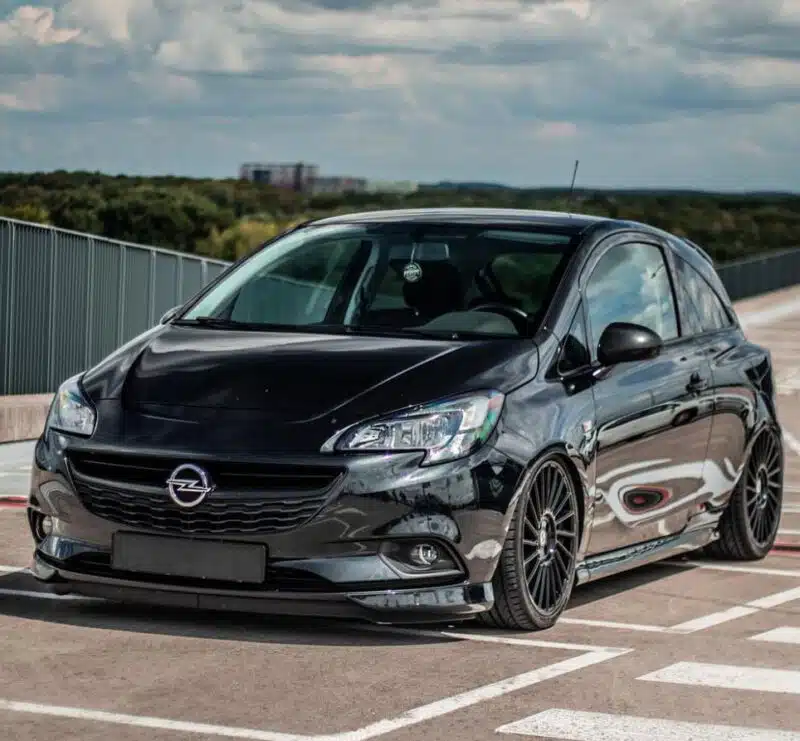 Lowered black Corsa E in a parking lot