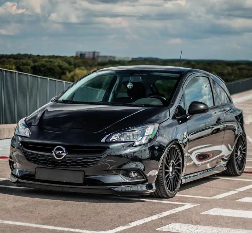 Lowered black Corsa E in a parking lot