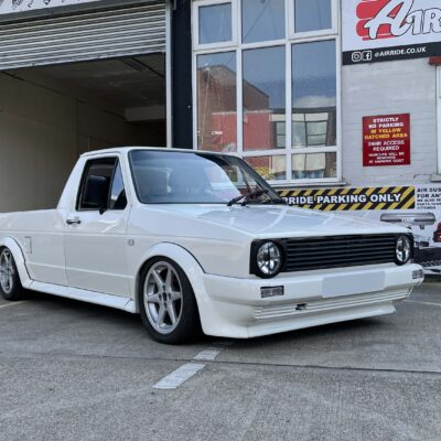 White Mk1 VW Caddy shown lowered outside AirRide workshop