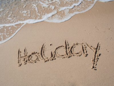 Holiday written in the sand