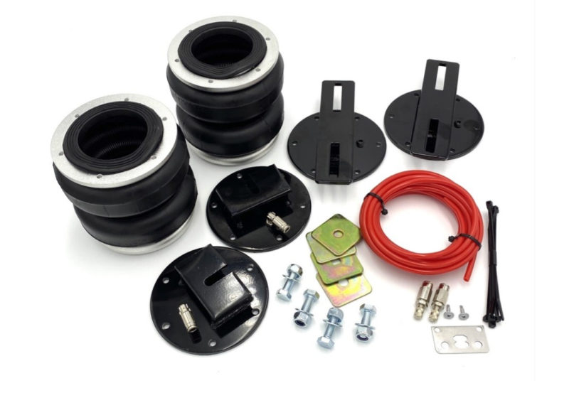 Air suspension kit laid out with airbags and metal brackets