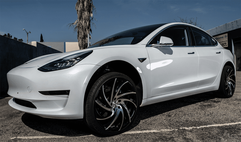 White Tesla Model 3 fully jacked up on air suspension