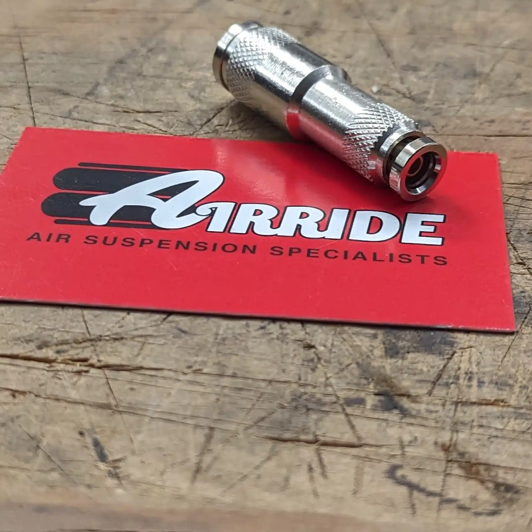3/8 inch to 1/4 inch solid metal reducer pictured on AirRide business card