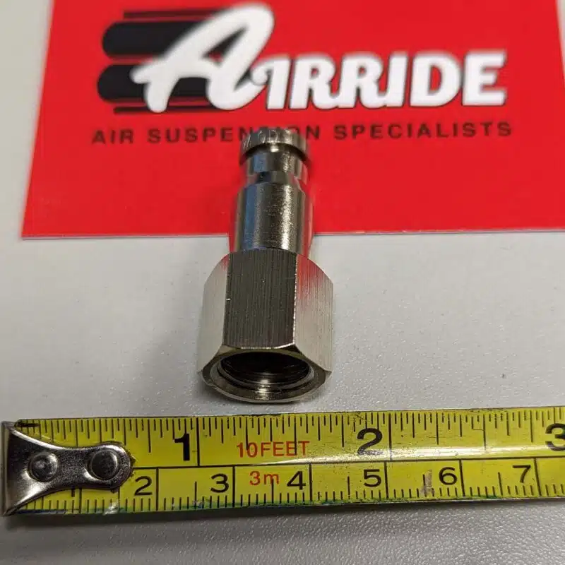 Close up of a 1/4 inch Female NPT to PTC fitting with a ruler
