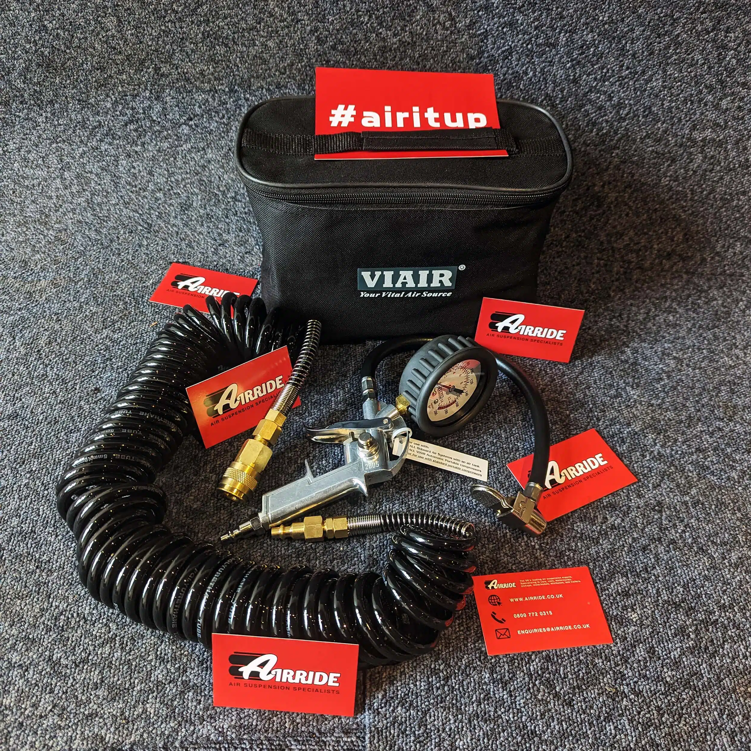 Viair mechanical tyre inflator kit laid out on blue background