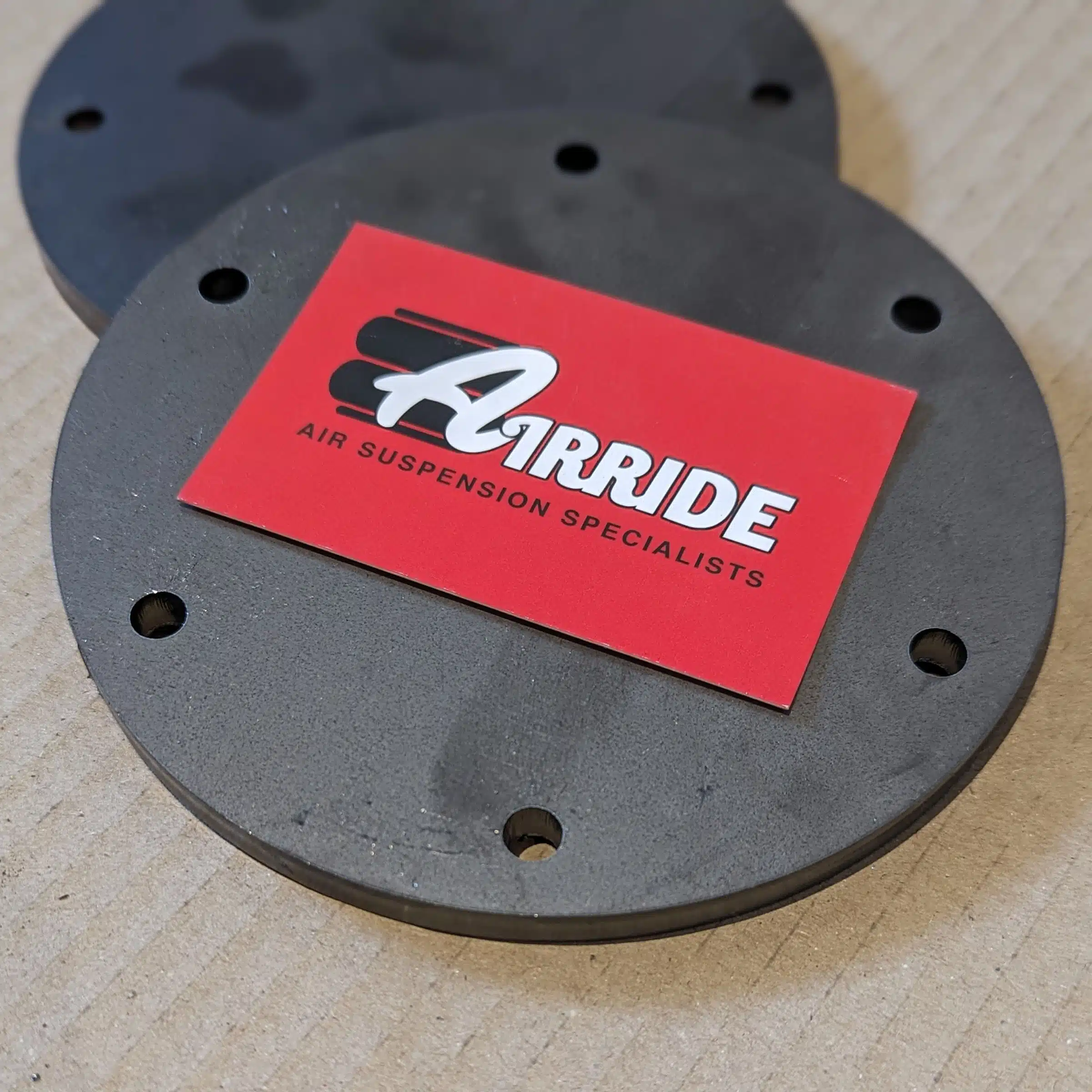 Close up of Boss 2500 bag end plates and AirRide business card on cardboard