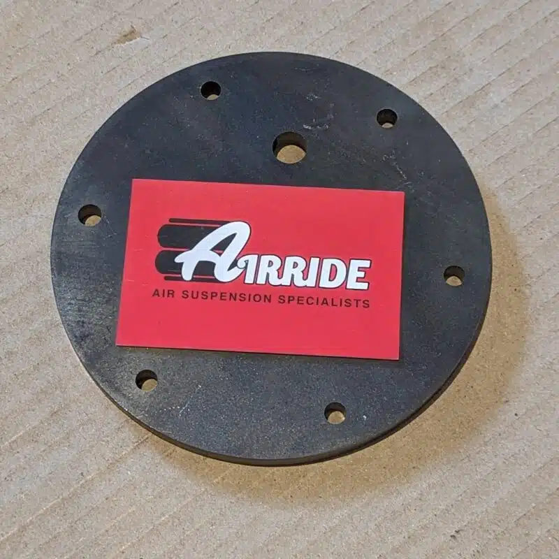 Close up of Boss 2500 bag top end plate and AirRide business card on cardboard