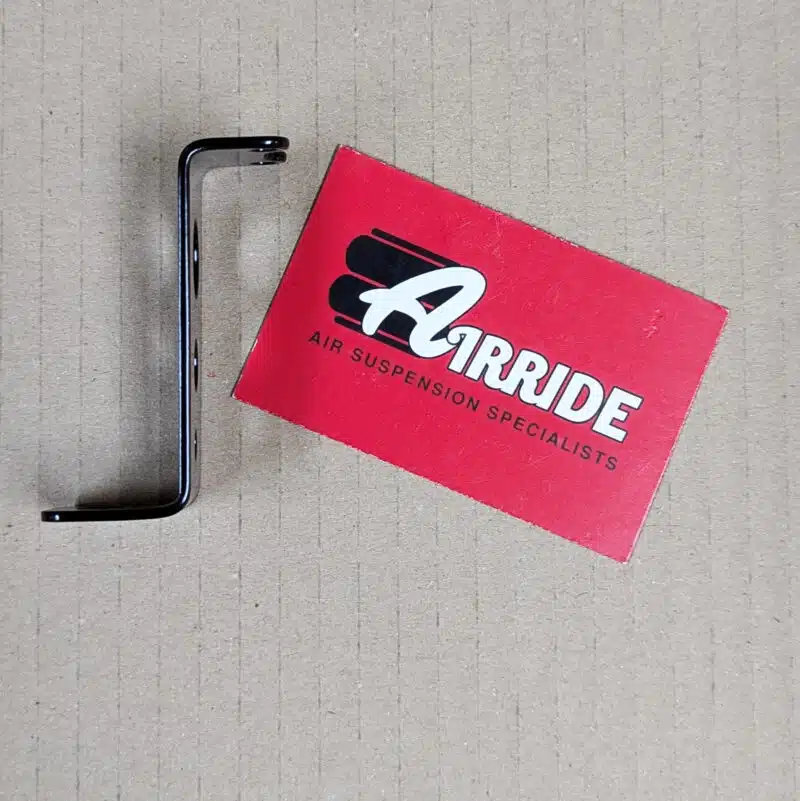 Side view of water trap bracket on beige background